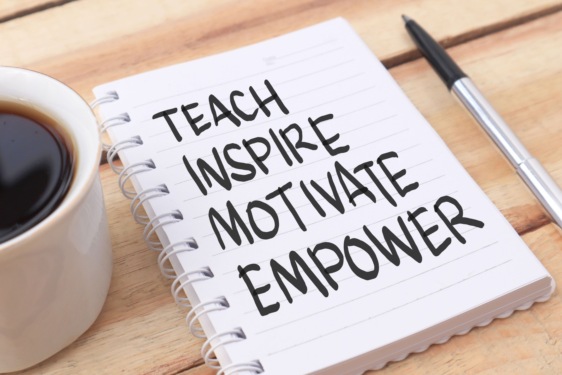 Teach inspire motivate empower, text words typography written on paper against wooden background, life and business motivational inspirational